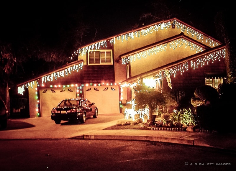 image depicting a home decorated with christmas lights