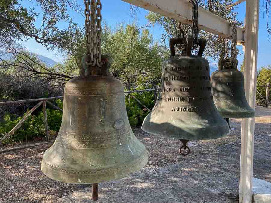 Church bells displayed in a monastery courtyard in Greece