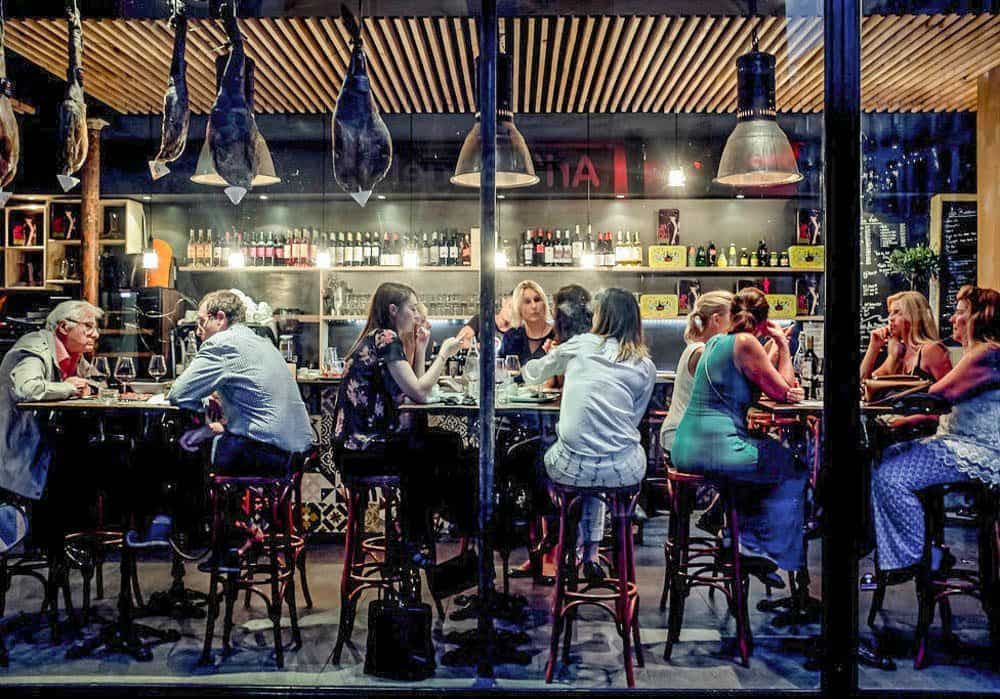 Image depicting people dining late at night in Europe