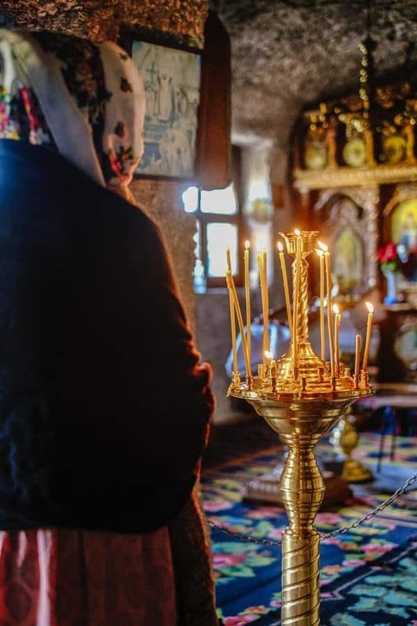 woman praying in an Orthodox Church - Romanian Religious Culture