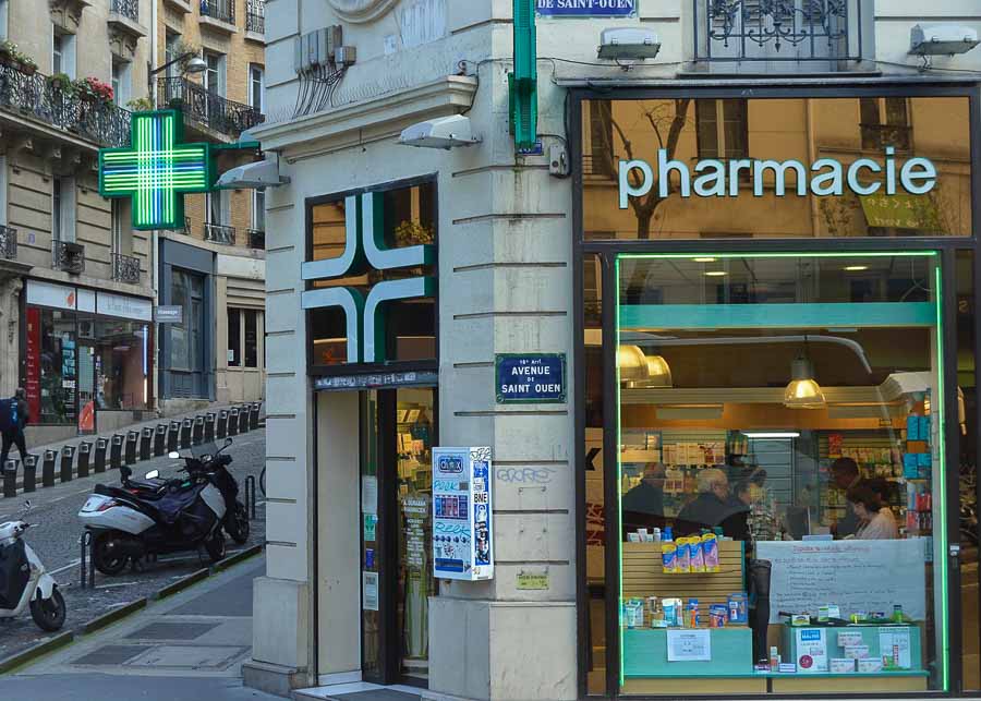 Paris pharmacy displaying cosmetics and perfumes in the window.