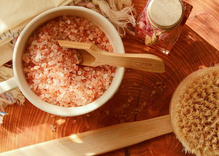 Bath salts in a jar with a wooden spoon