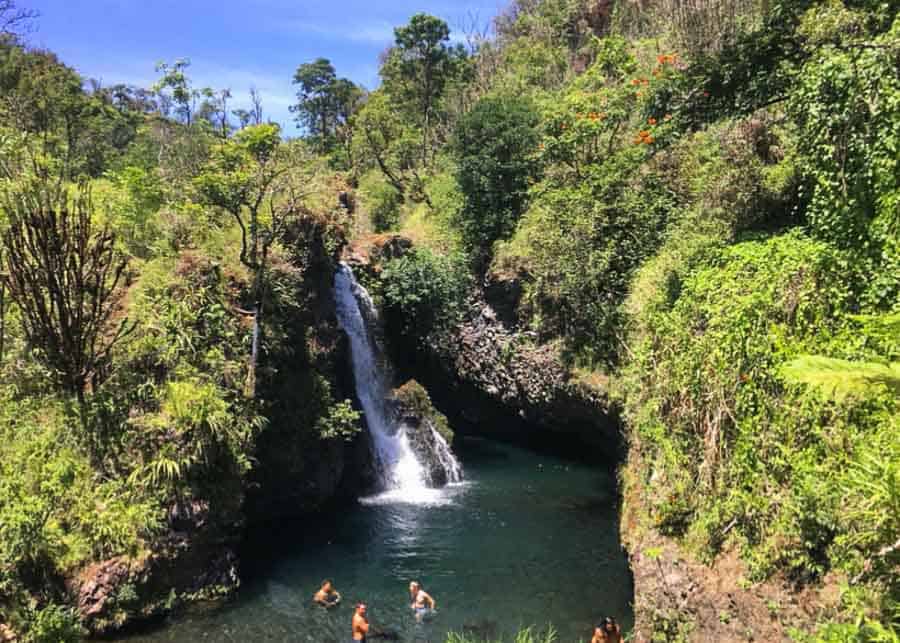 People swimming in the Pua'a Kaa falls