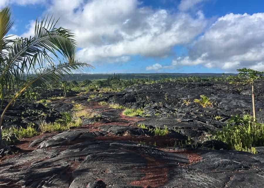 lava road in Hawaii leading to a black sand beach