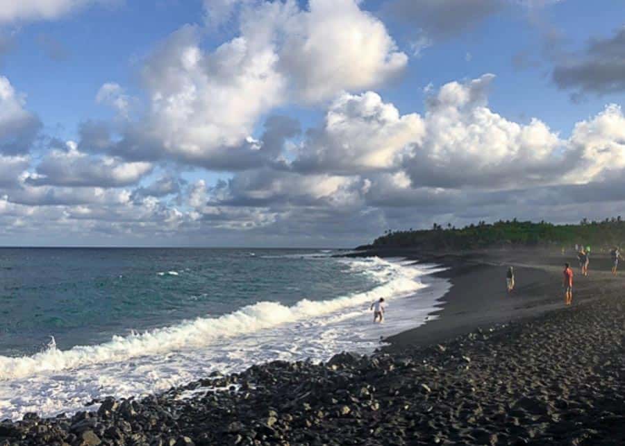 visiting a black sand beach on the Big Island