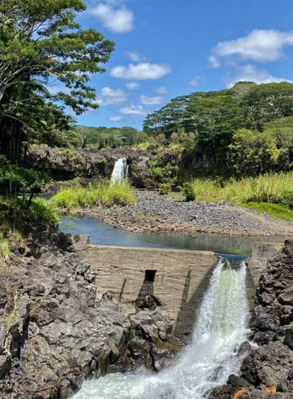 View of the Waiale falls and the green vegetation in the background