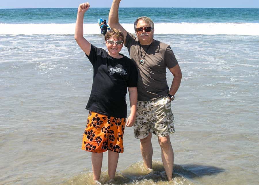 men in the ocean looking happy