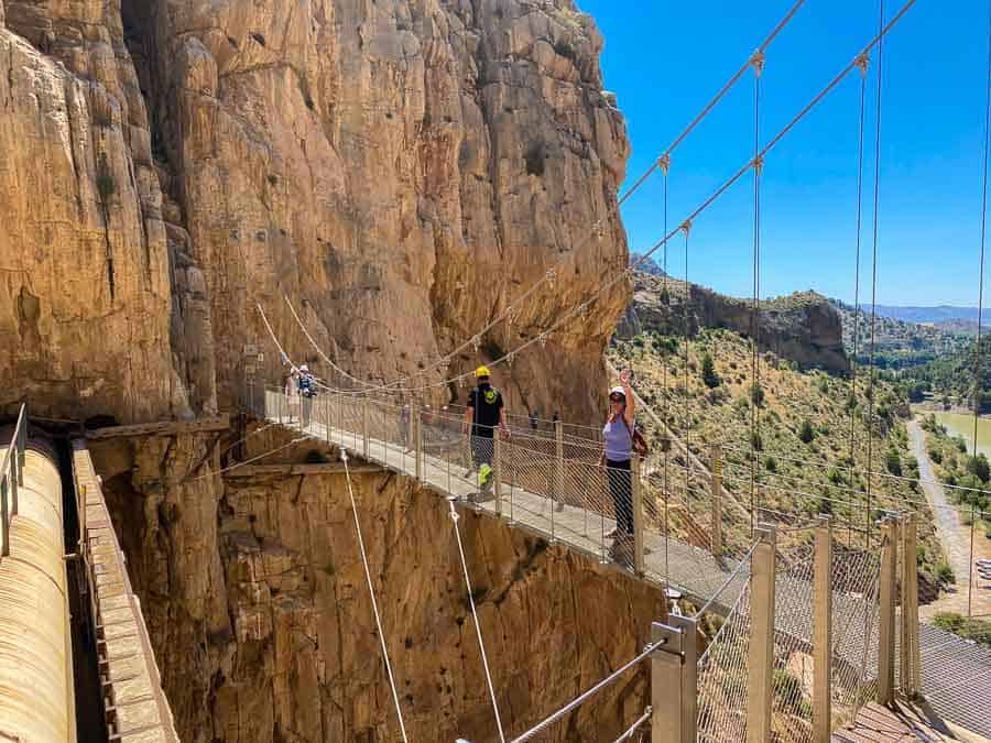 Crossing the Puente del Rey suspension bridge