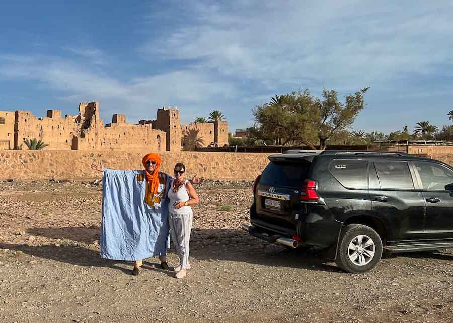 standing next to our driver  when visiting Morocco