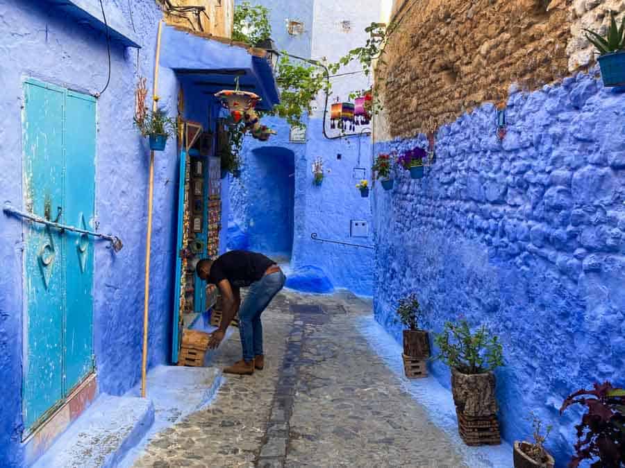 Man in front of his house in Chefchaouen, the Blue City of Morocco
