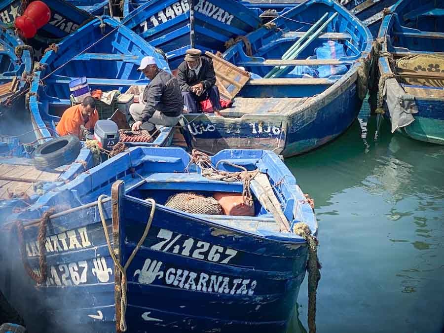 Fisherman repairing their boats in the harbor