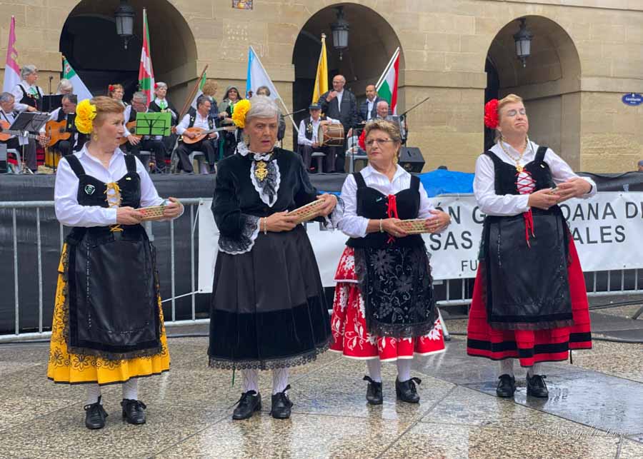 Locals dressed in folk Basque costumes performing a dance