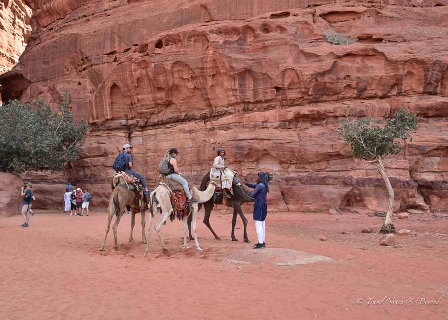 Tourists exploring the Wadi Rum desert in Jordan by camels