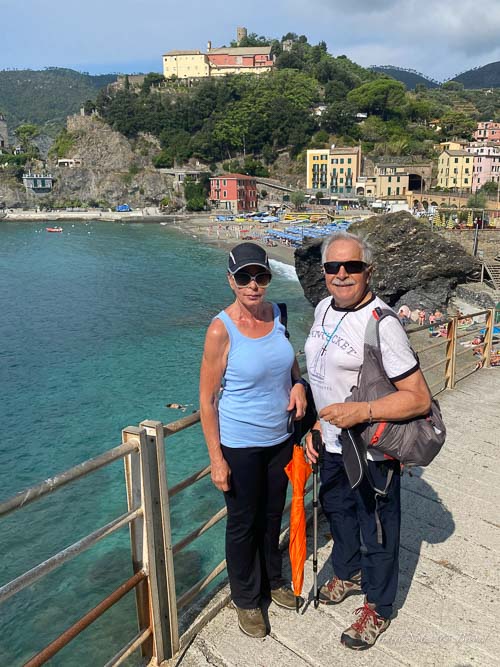 image depicting tourists walking along the shore
