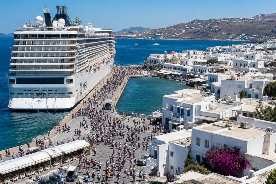 Cruise ship unloading thousands of passengers in the small port of Mykonos