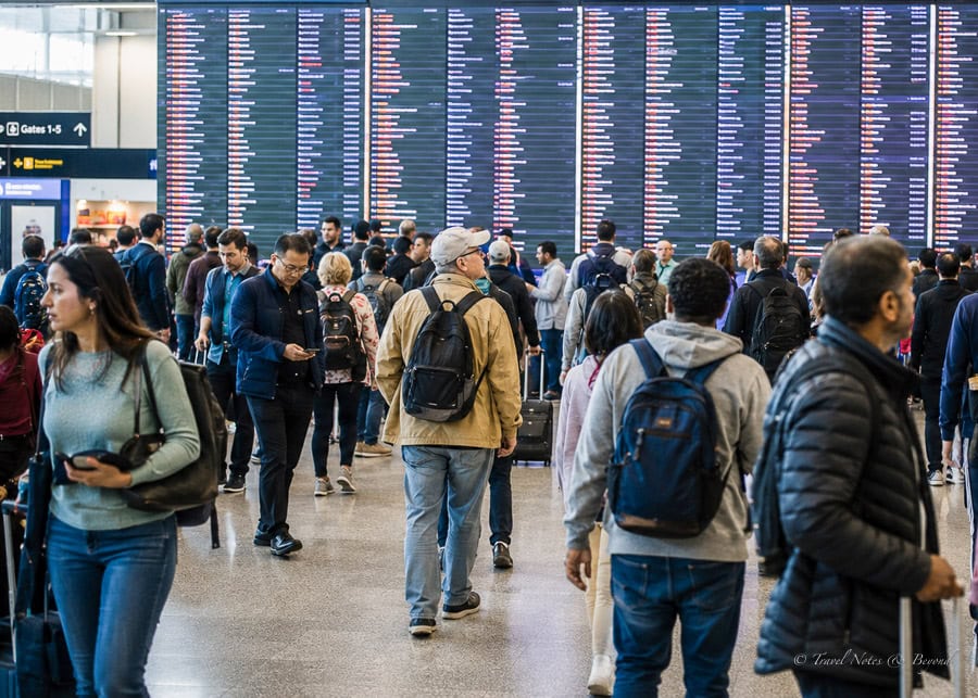 Airport departures board displaying international flights.